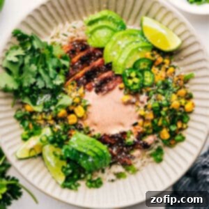 Street Corn Chicken Rice Bowl in a ceramic bowl with a spoon.
