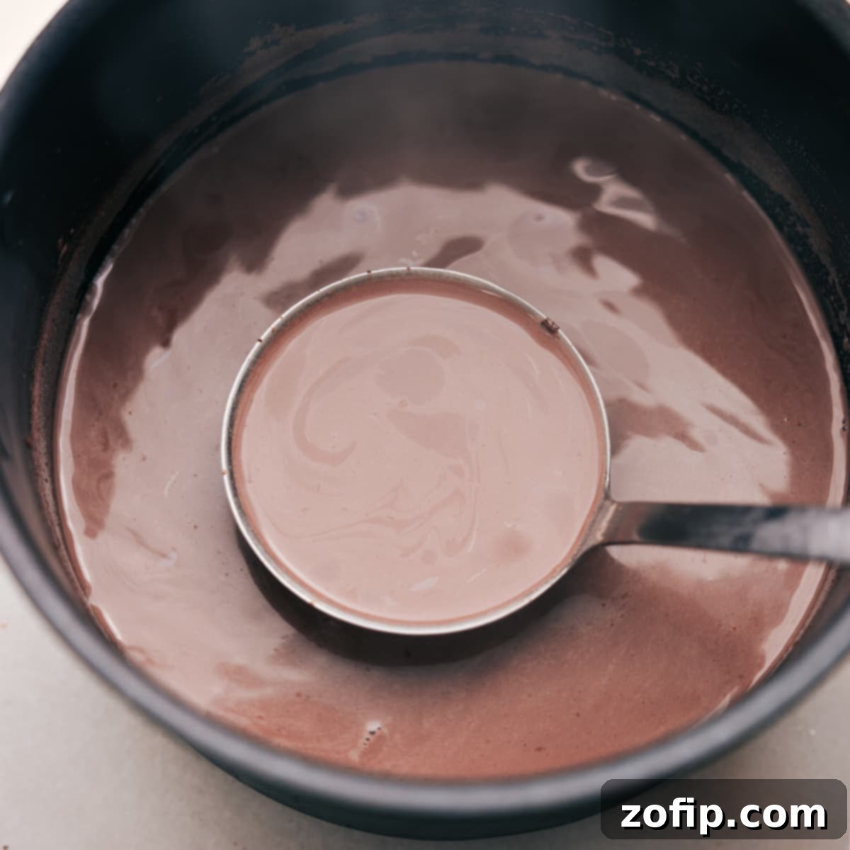 Ready-to-serve, comforting Mexican Hot Chocolate Warm, inviting Mexican Hot Chocolate prepared for pouring into a cup, promising a cozy, flavorful experience.