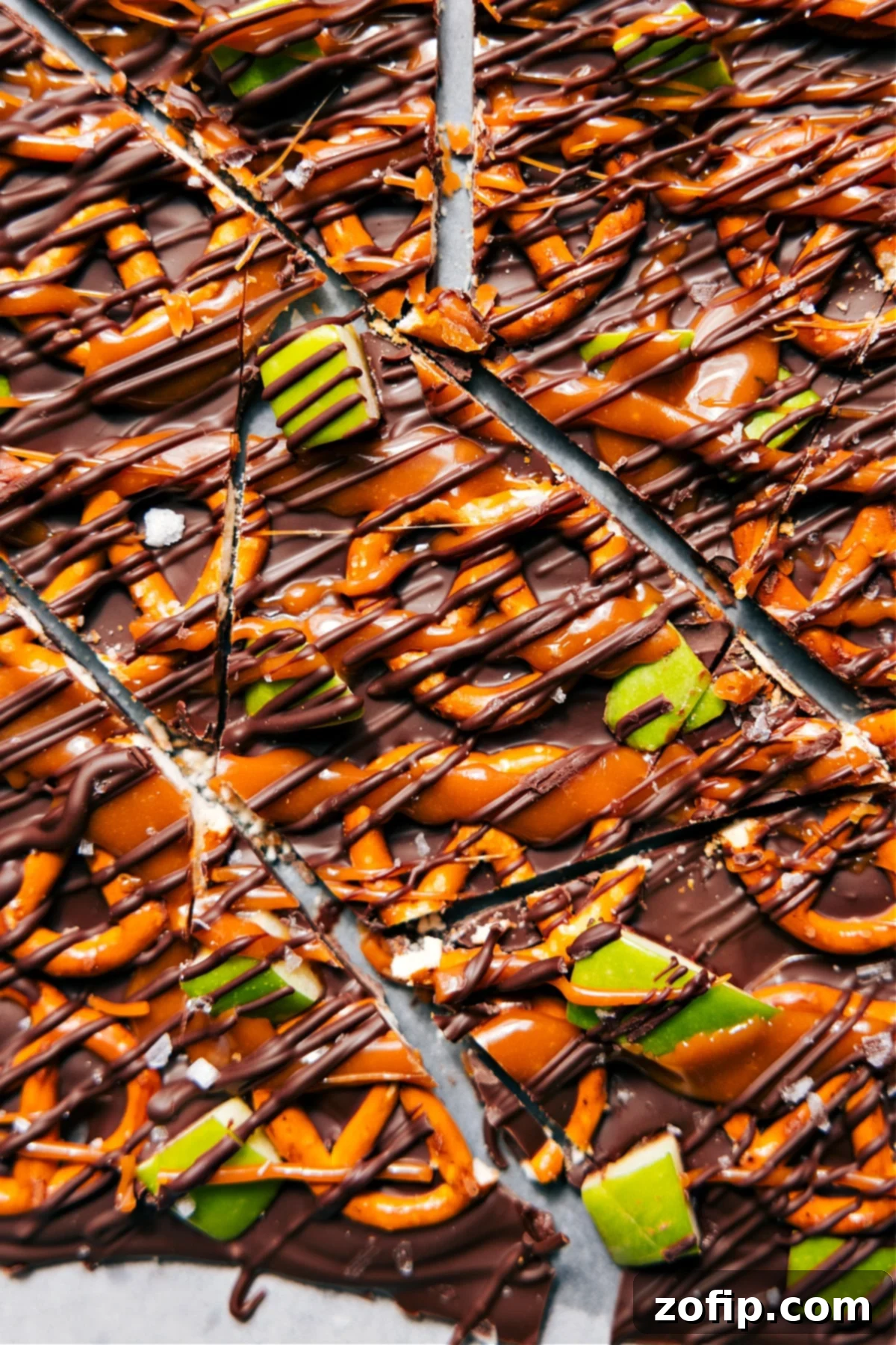 Caramel Apple Bark pieces cut into squares and ready to serve on a parchment-lined tray.