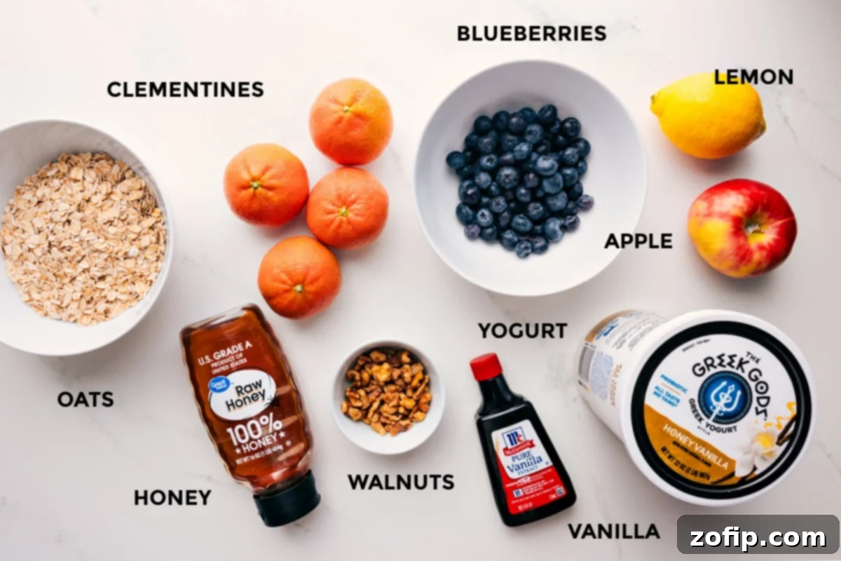 Ingredients In Princess Diana's Breakfast Ingredients for Princess Diana's Breakfast recipe: oats, honey, walnuts, clementines, blueberries, yogurt, vanilla, lemon, and apple, all prepped and ready for assembly.