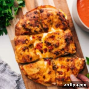 A close-up of a perfectly toasted Focaccia Grilled Cheese with melted cheese oozing out.