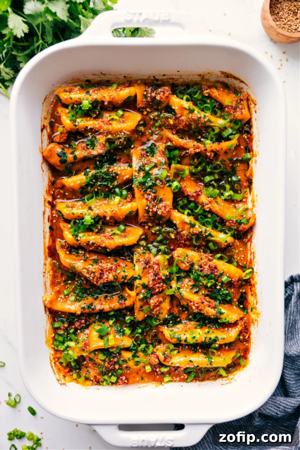 30-Minute One Pan Dumpling Dinner Recipe One Pan Dumpling Dinner, freshly baked and topped with vibrant green onions and fresh cilantro, straight out of the oven.