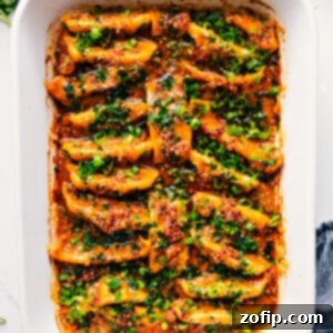 Easy Skillet Dumpling Feast 3 Close-up of One Pan Dumpling Dinner, showing cooked dumplings in a rich sauce, garnished with fresh herbs and chili crunch.