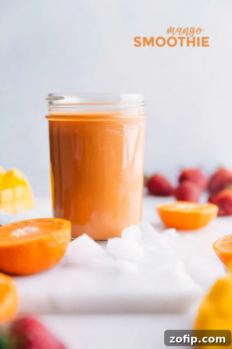 A perfectly prepared mango smoothie, chilled in a glass with a straw, ready to be enjoyed on a bright day.