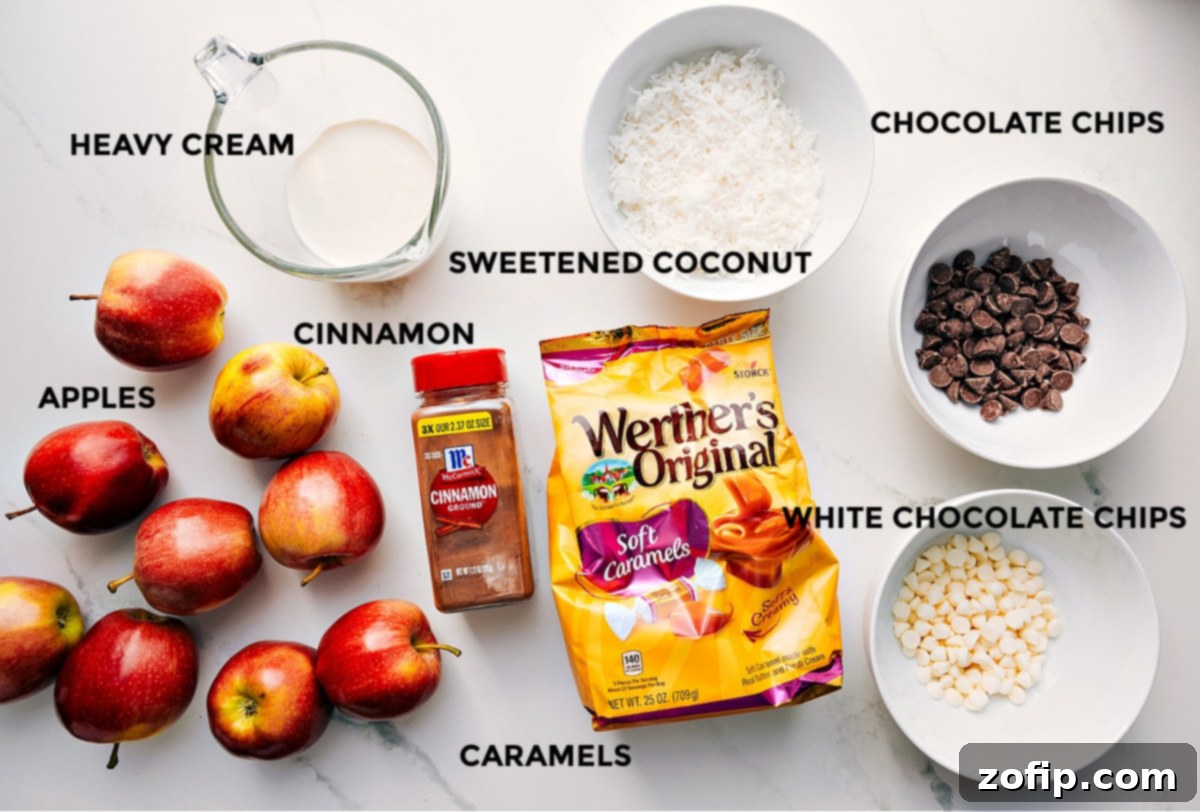 Ingredients In Caramel Apple Dessert Cups All the ingredients prepped and ready to assemble, including apples, heavy cream, cinnamon, sweetened coconut, caramels, chocolate chips, and white chocolate chips.