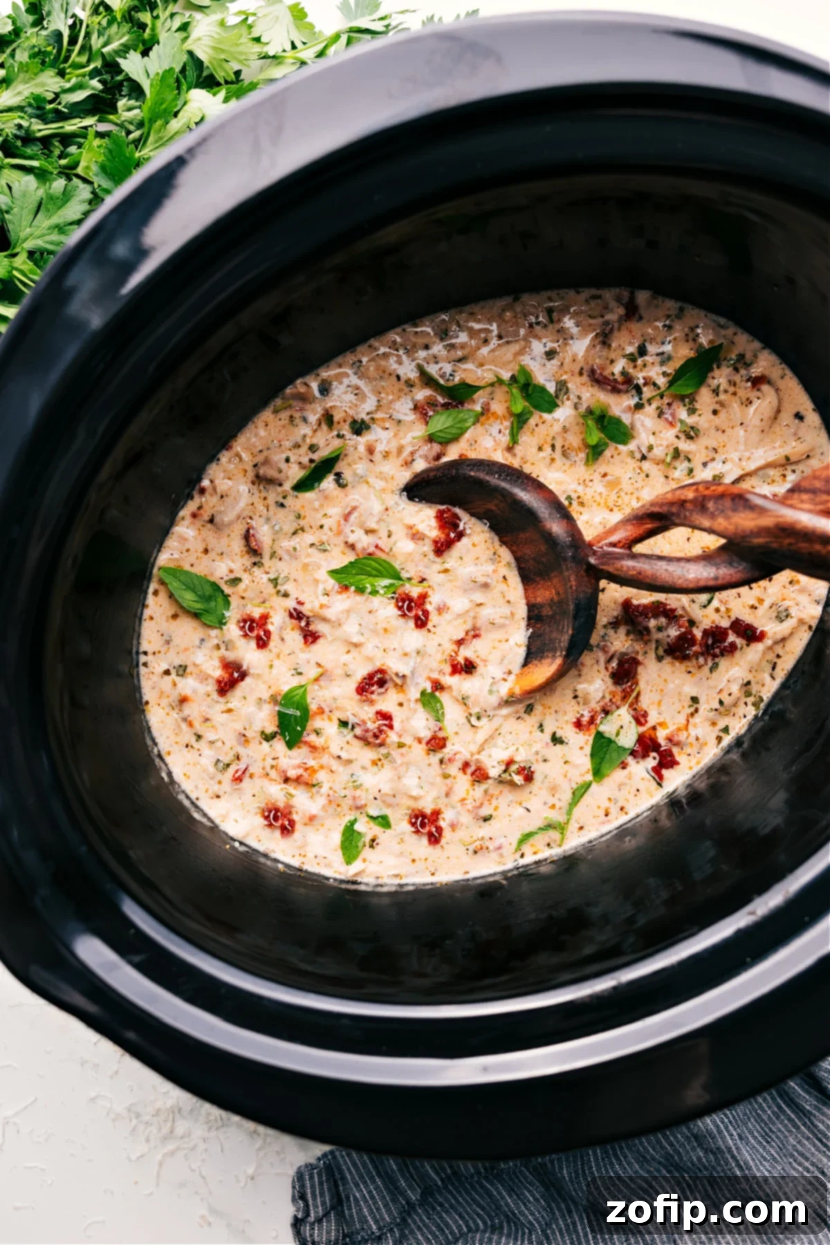 Simple And Delicious Crockpot Marry Me Chicken Recipe Crockpot Marry Me Chicken in a slow cooker, ready to be served, garnished with fresh basil.