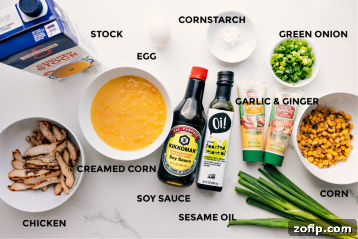 Ingredients In Chicken Corn Soup Recipe All the ingredients for Chicken Corn Soup recipe prepped out for easy assembly, including chicken stock, creamed corn, frozen corn, soy sauce, sesame oil, cornstarch slurry, ginger paste, garlic paste, green onions, and cooked shredded chicken.