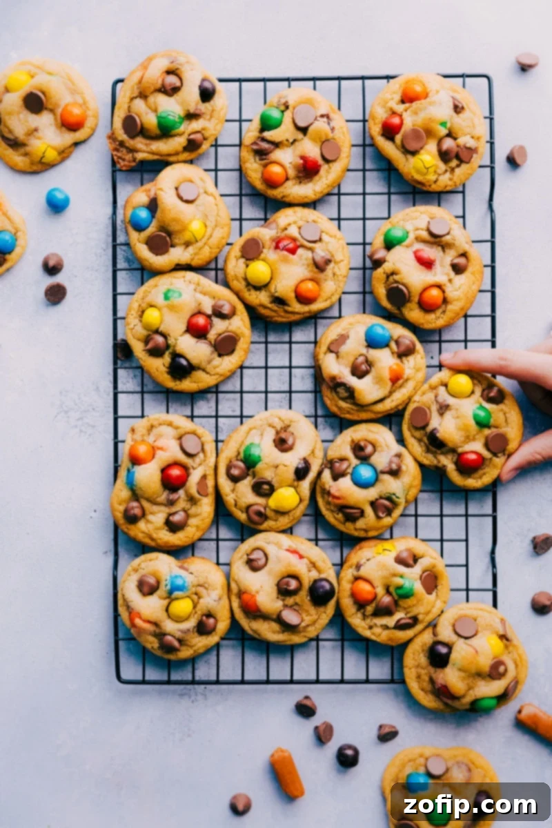 Overhead image of large, perfectly baked Caramel Stuffed Cookies, revealing their gooey caramel centers and colorful M&M's.