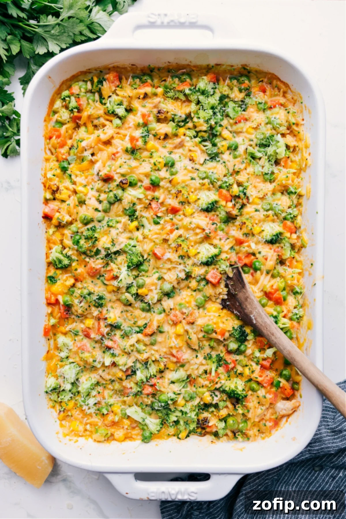 Golden-brown Chicken Orzo Bake bubbling in a casserole dish, fresh from the oven and ready to serve.
