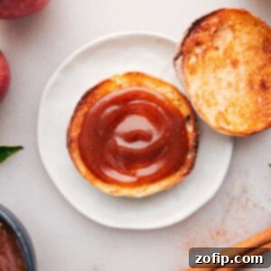 Thick spread of apple butter atop a golden slice of toast, ready to be enjoyed.