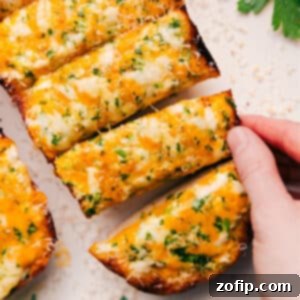 Ultimate Cheesy Garlic Bread 3 Close-up of a perfectly baked cheesy bread, golden brown and bubbly, ready to be enjoyed.