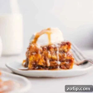 A slice of bread pudding topped with a scoop of ice cream, served warm as a delicious dessert.