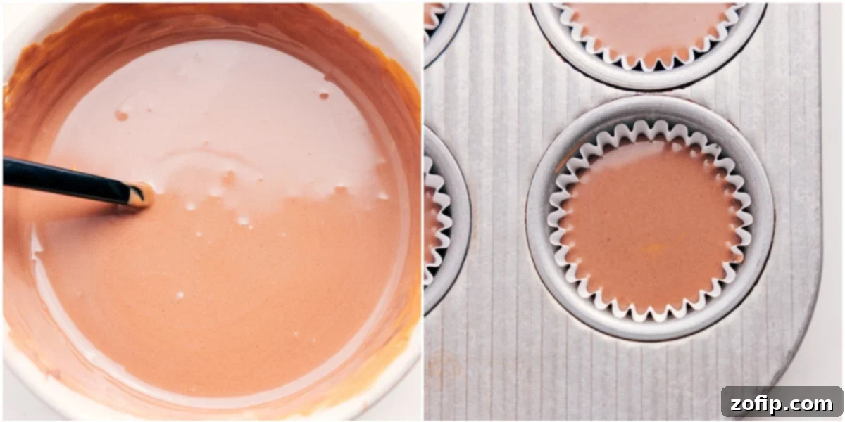 Melted chocolate and peanut butter mixture being poured into mini muffin liners from a liquid measuring cup.