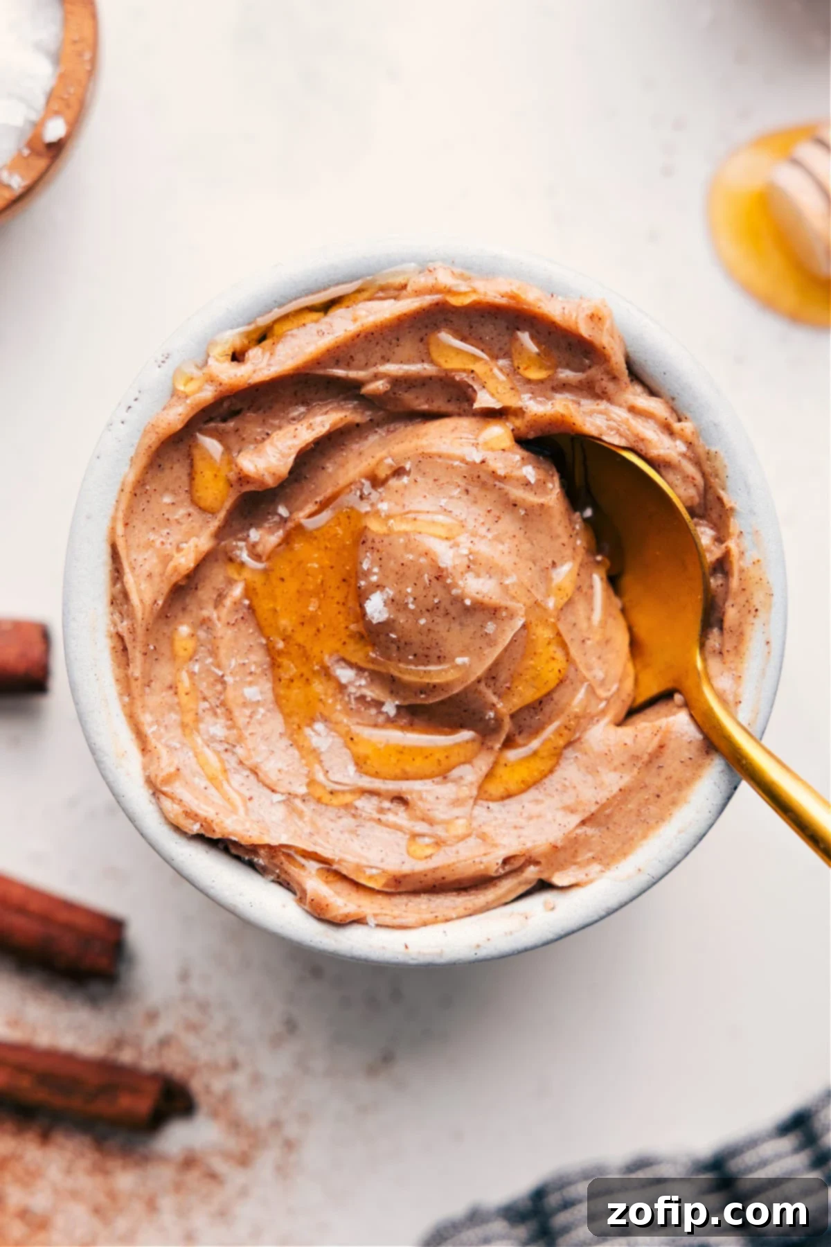 A beautifully presented bowl of creamy Honey Butter Recipe, adorned with an extra swirl of golden honey and a sprinkle of flaky sea salt, invitingly ready to be served.