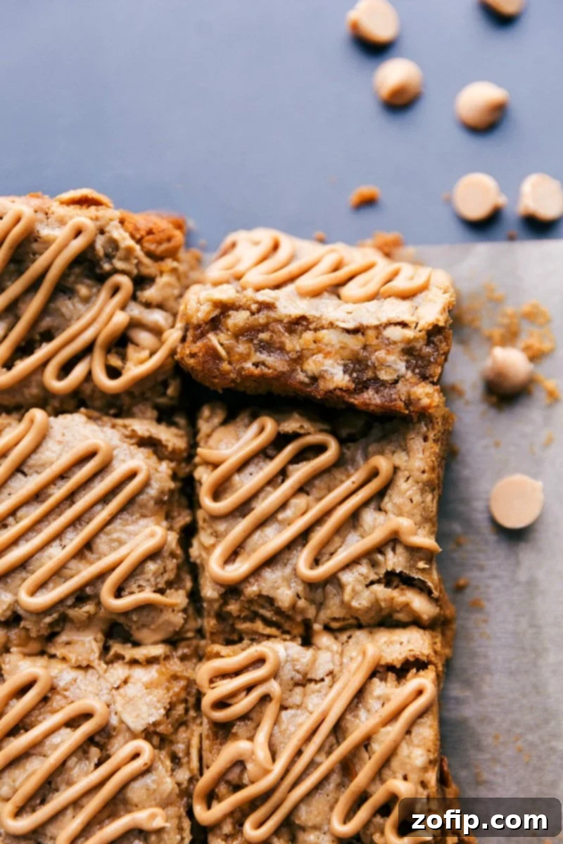 Close-up of freshly baked oatmeal bars with a generous peanut butter glaze drizzled on top, ready for enjoyment.