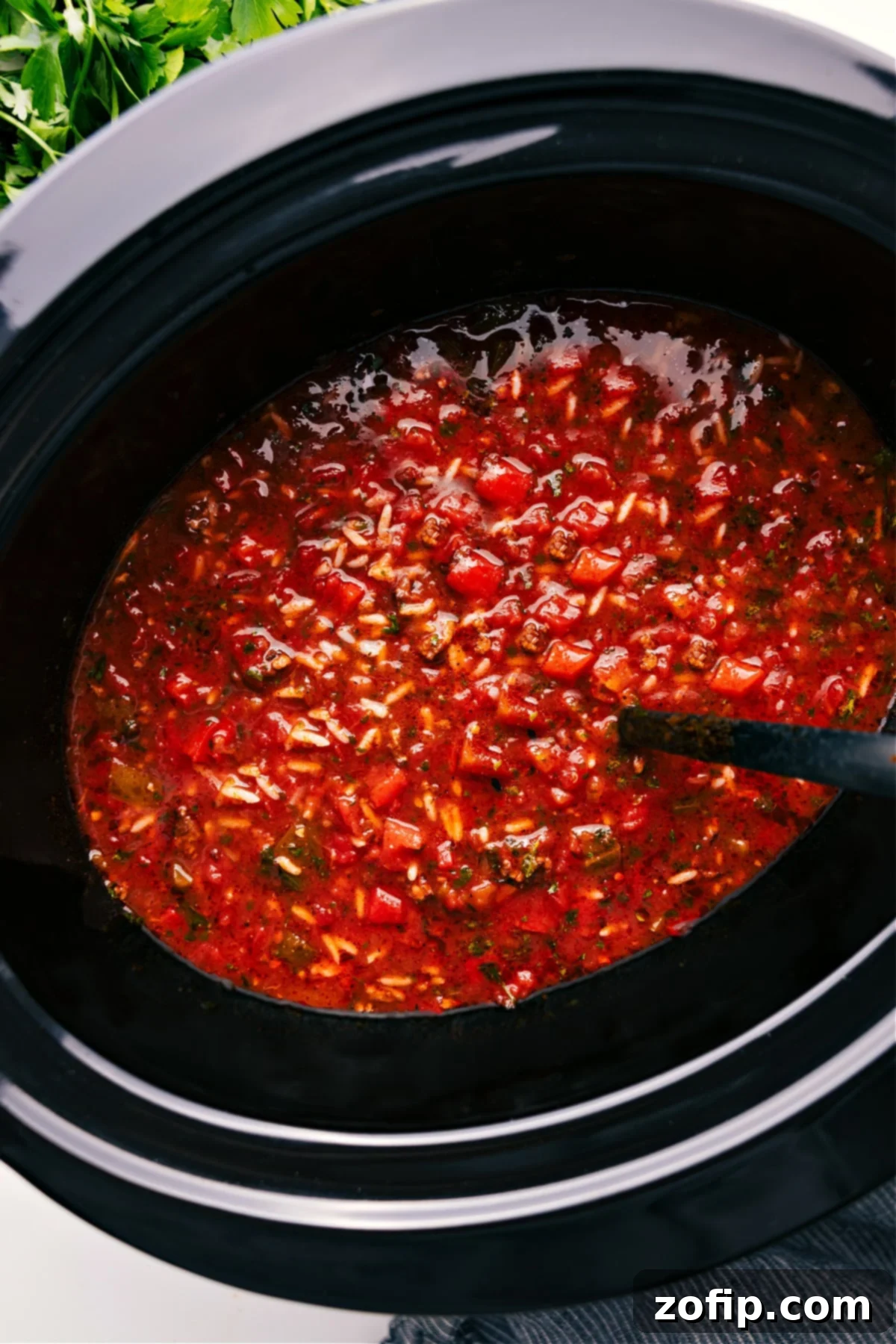 Hearty Crockpot Stuffed Pepper Soup simmering in a slow cooker, ready to be served and enjoyed.