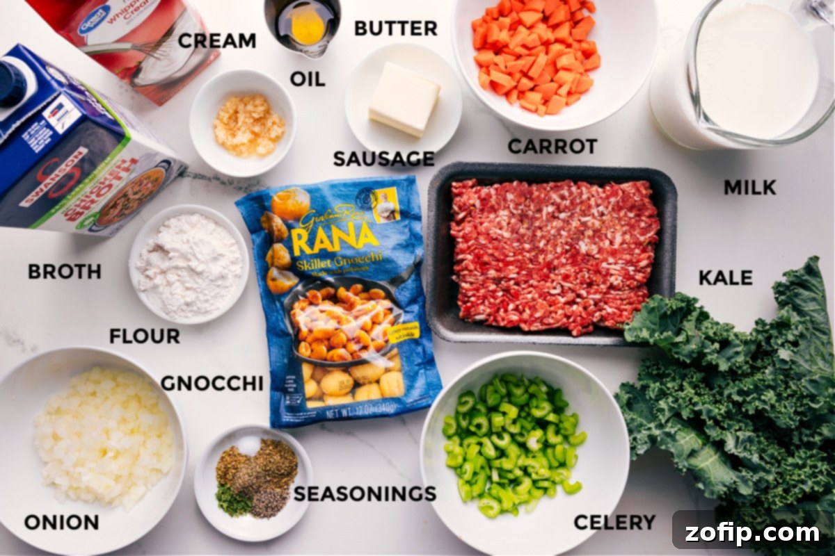 All the fresh ingredients prepped for Sausage Gnocchi Soup, including ground Italian sausage, diced onions, celery, carrots, minced garlic, chicken broth, whole milk, heavy cream, refrigerated gnocchi, and fresh kale.