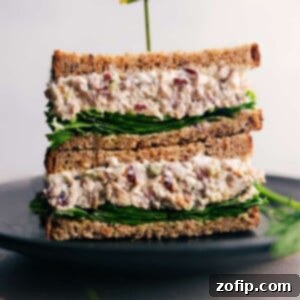 Turkey salad sandwich, cut in half, filled with creamy turkey salad and fresh lettuce, perfectly prepared and ready to be enjoyed.