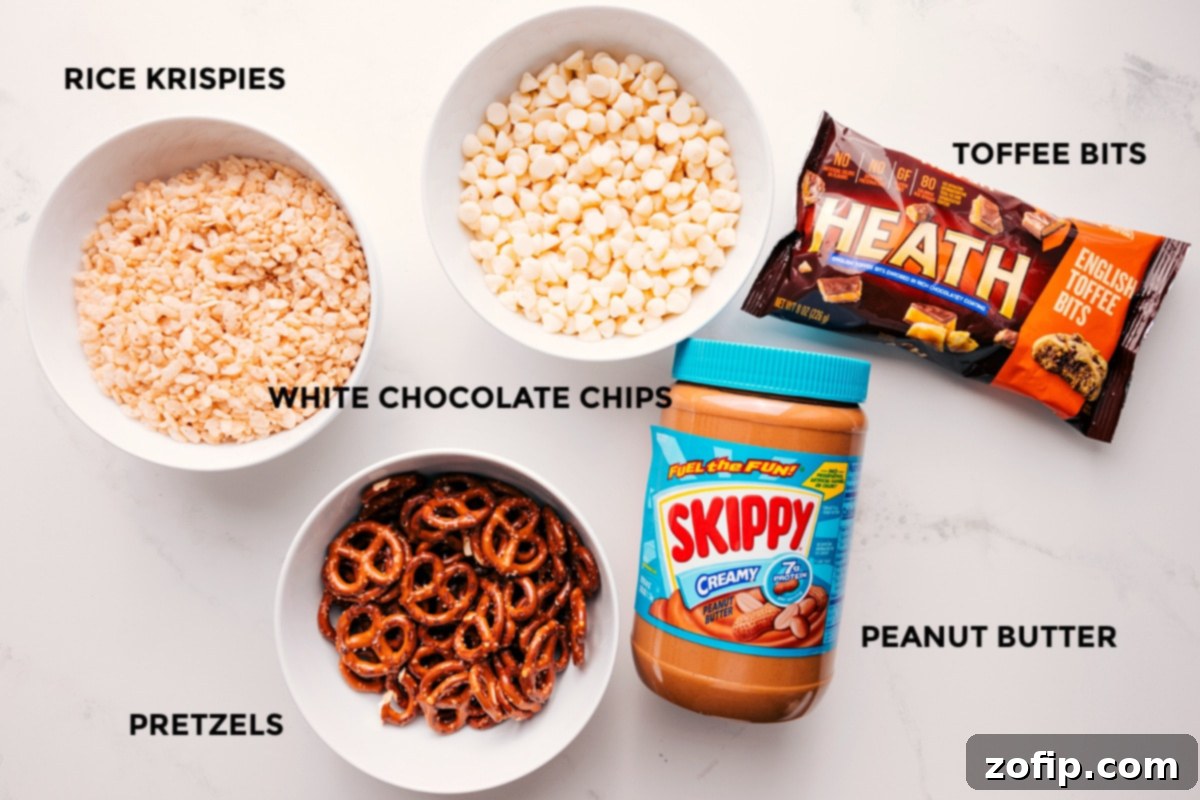 All the essential ingredients for White Chocolate Pretzel Clusters prepped for easy assembly: premium white chocolate chips, creamy peanut butter, crisp Rice Krispies cereal, crunchy pretzels, and buttery toffee bits.