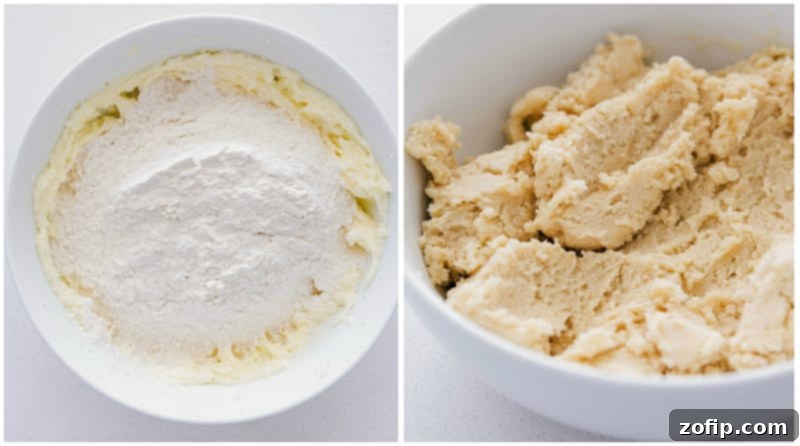 Flour being added to the dough and it all being mixed together for this thumbprint cookie recipe.