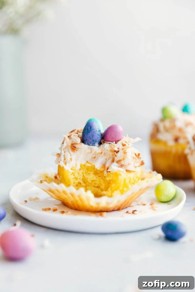 Colorful Easter Cupcake Delights 3 Close-up of a bite taken out of an Easter cupcake, with other bird's nest cupcakes in the background