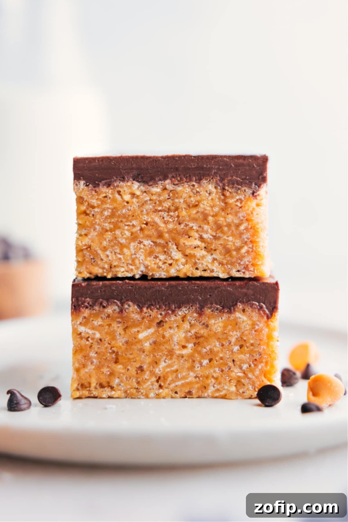 The Best Scotcheroos Recipe: A Delicious No-Bake Treat Two Scotcheroos bars stacked on top of each other, showcasing their layers of crispy cereal, peanut butter, and chocolate butterscotch topping.