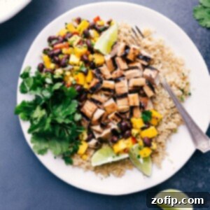 Delicious chicken quinoa bowl with fresh mango salsa and cilantro on the side.
