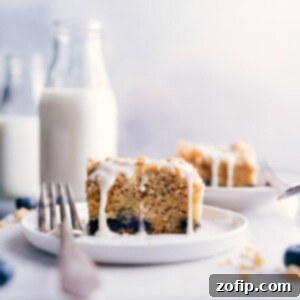 Piece of coffee cake on a plate, with a fork on the side.