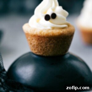 Delicious and festive ghost cookies, perfect for serving at a Halloween party, decorated to look like cute ghosts.