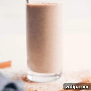 Delicious Oatmeal Smoothie in a glass with a straw, ready to be enjoyed.