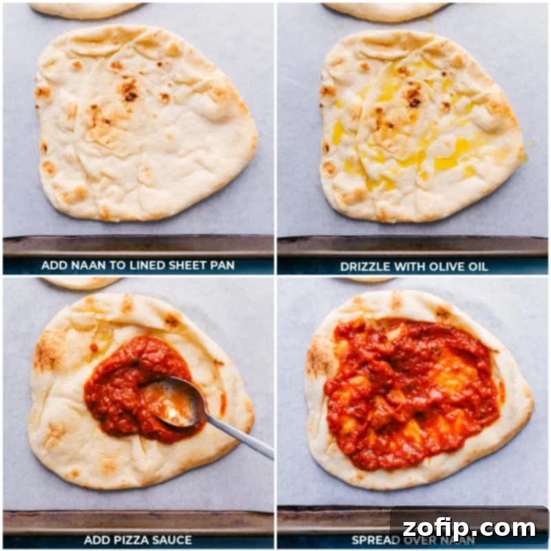 Naan flatbreads laid out on a sheet pan, lightly oiled, and topped with pizza sauce, ready for additional toppings.
