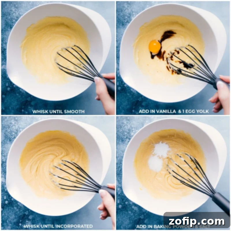 Soft, tender, and chewy sugar cookie bars piled high with a sweet buttercream frosting and loads of sprinkles! Recipe via ChelseasMessyApron #dessert #best #quick #easy #frosting #sprinkles #sugarcookie #bars Process shots showing vanilla extract, egg yolk, baking powder, and salt being added and mixed into the sugar cookie bar batter