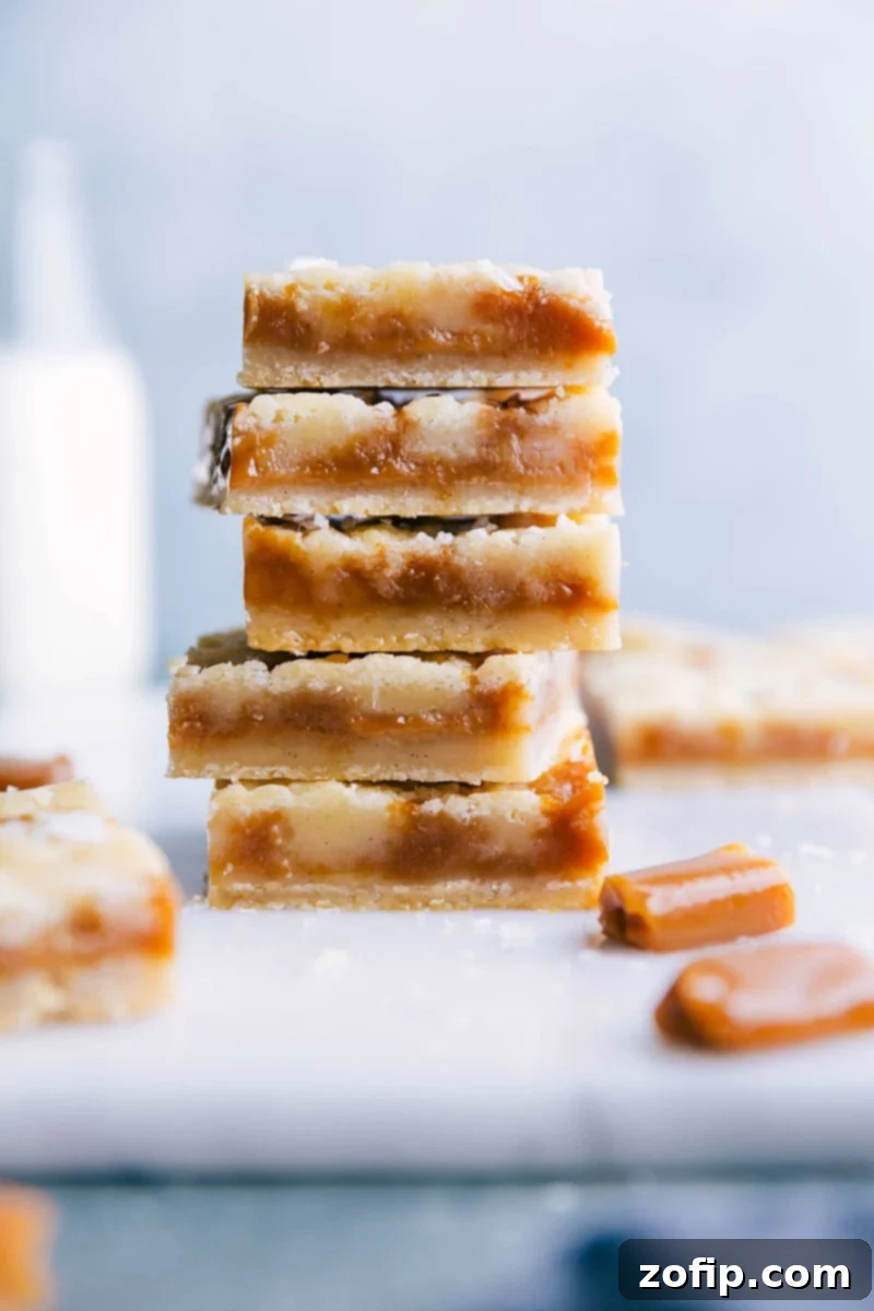 Caramel Cookie Bars with Gooey Interior A stack of freshly baked caramel cookie bars, sliced to display a soft and gooey caramel-filled interior, surrounded by a crisp golden crust, rich in flavor.