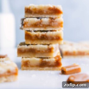 Chewy Caramel Dream Bars 2 A stack of freshly baked caramel cookie bars, sliced to display a soft and gooey caramel-filled interior, surrounded by a crisp golden crust, rich in flavor.