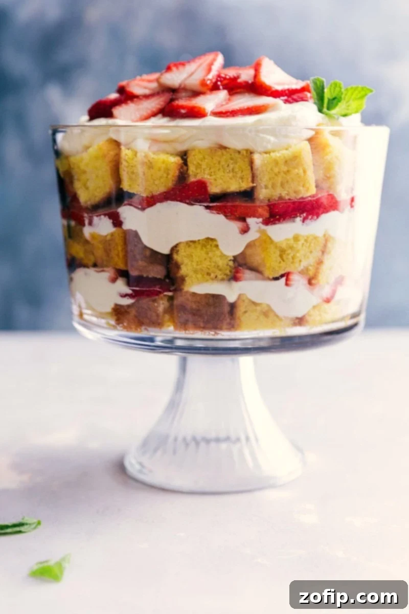 Delicious Layered Strawberry Shortcake Trifle Dessert Strawberry shortcake trifle with elegant layers of cake, fresh strawberries, and cream in a clear trifle dish.