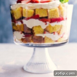 Strawberry Dream Delight 2 Strawberry shortcake trifle with layers of cake, fresh strawberries, and cream in a glass bowl.