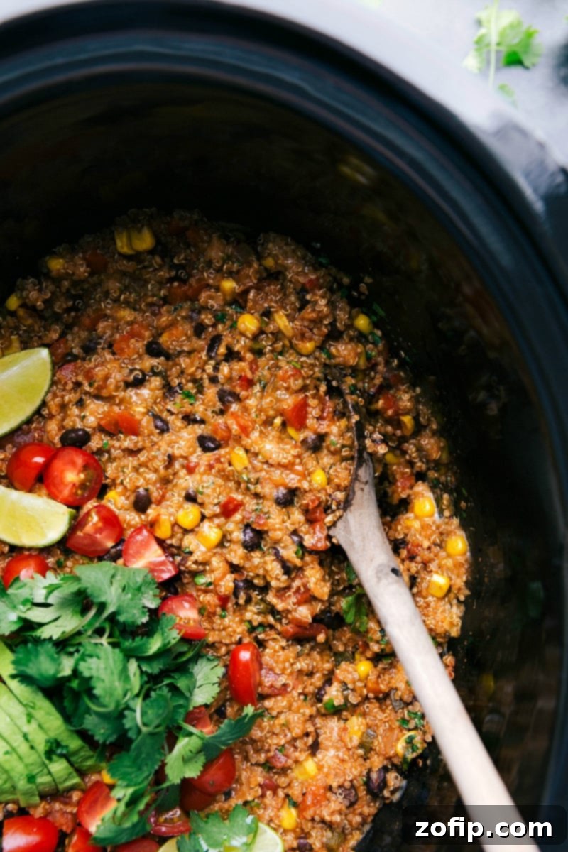 Vibrant Tex-Mex quinoa casserole in a crockpot, brimming with fresh vegetables and cilantro, ready to be served.