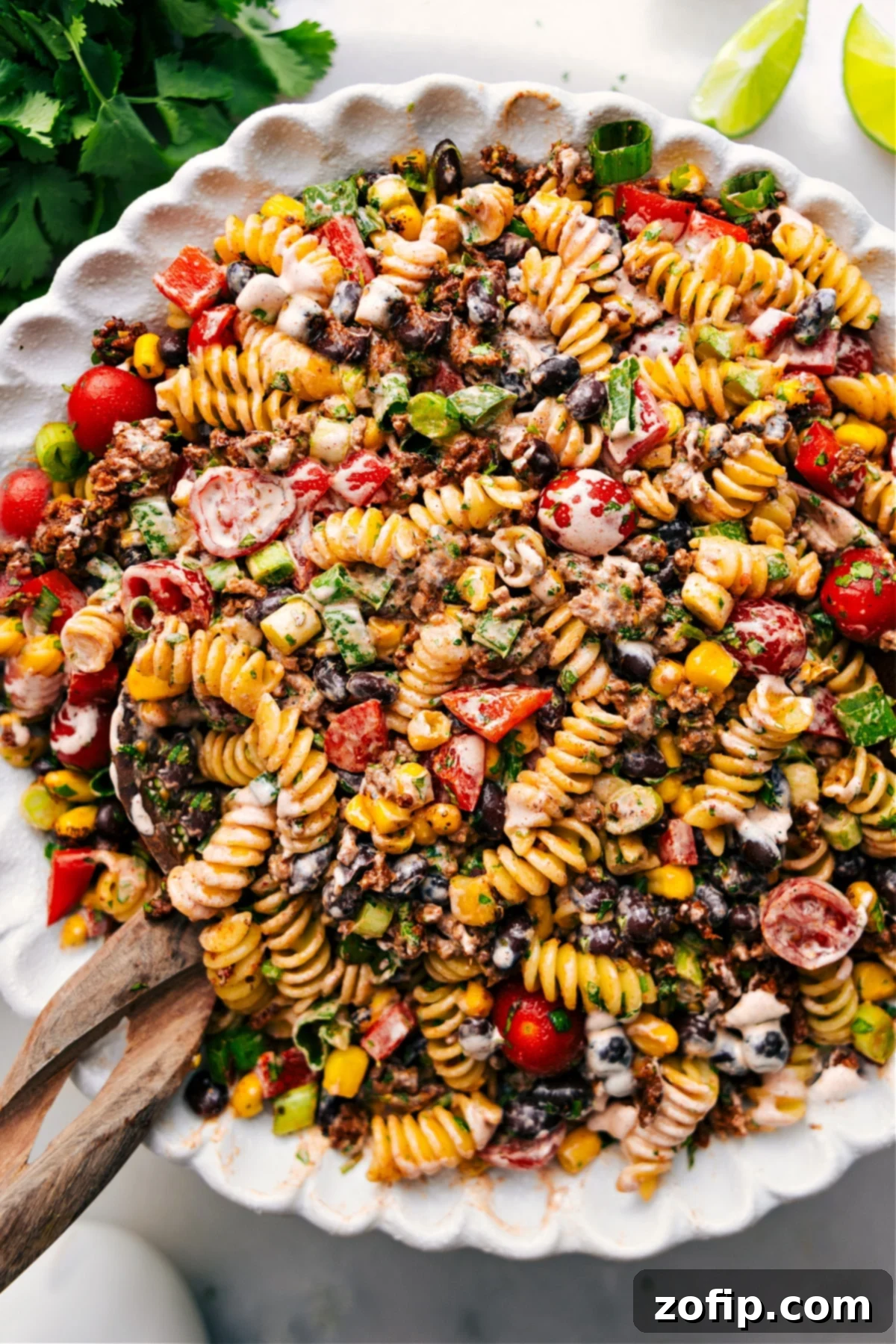 Taco Pasta Salad in a large bowl, garnished with fresh cilantro, ready to be served.
