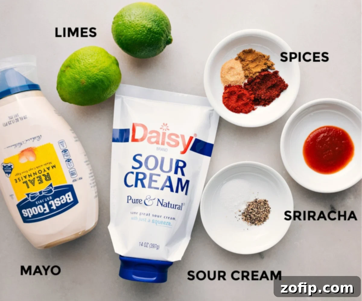 All the fresh ingredients for the creamy chili-lime dressing, including mayonnaise, sour cream, whole limes, and various spices, laid out on a cutting board, ready to be combined.