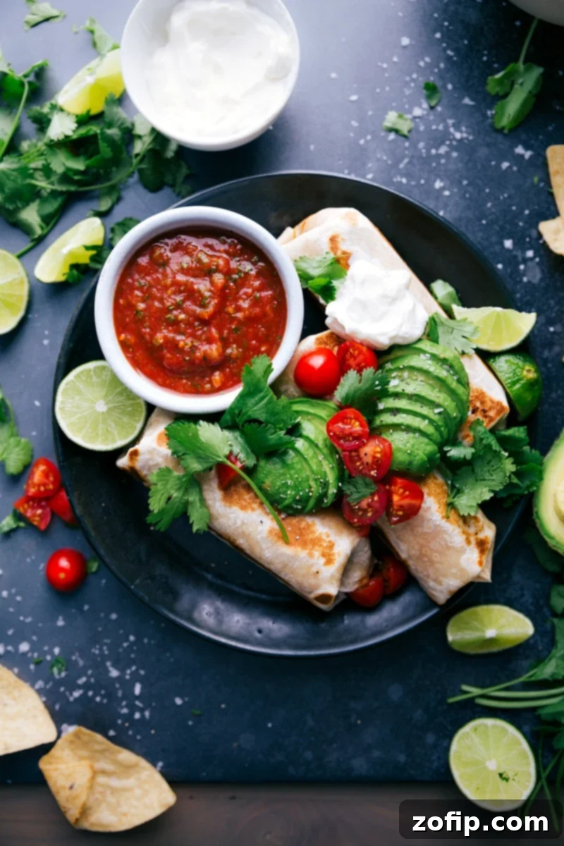 Healthy Burritos Garnished with Avocados, Tomatoes, Fresh Herbs, and Sour Cream Delicious healthy burritos garnished with sliced avocados, fresh tomatoes, vibrant herbs, and a swirl of sour cream, presented invitingly on a plate.