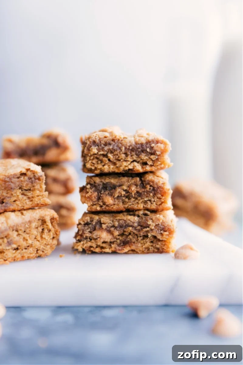 Image of the peanut butter banana bars stacked on top of each other, showcasing their inviting texture and golden-brown edges. These healthy, chewy bars are perfect for a snack or dessert.