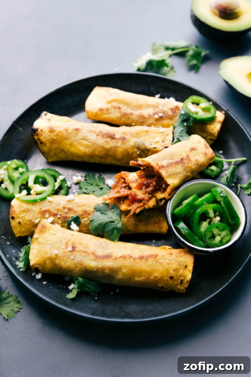 Finished meal on a plate with one portion broken apart, revealing the inside with tender meat in flavorful sauce.