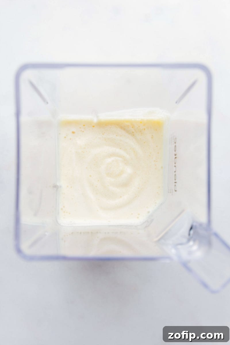 Freshly blended Orange Julius still in the blender, showing its frothy texture.