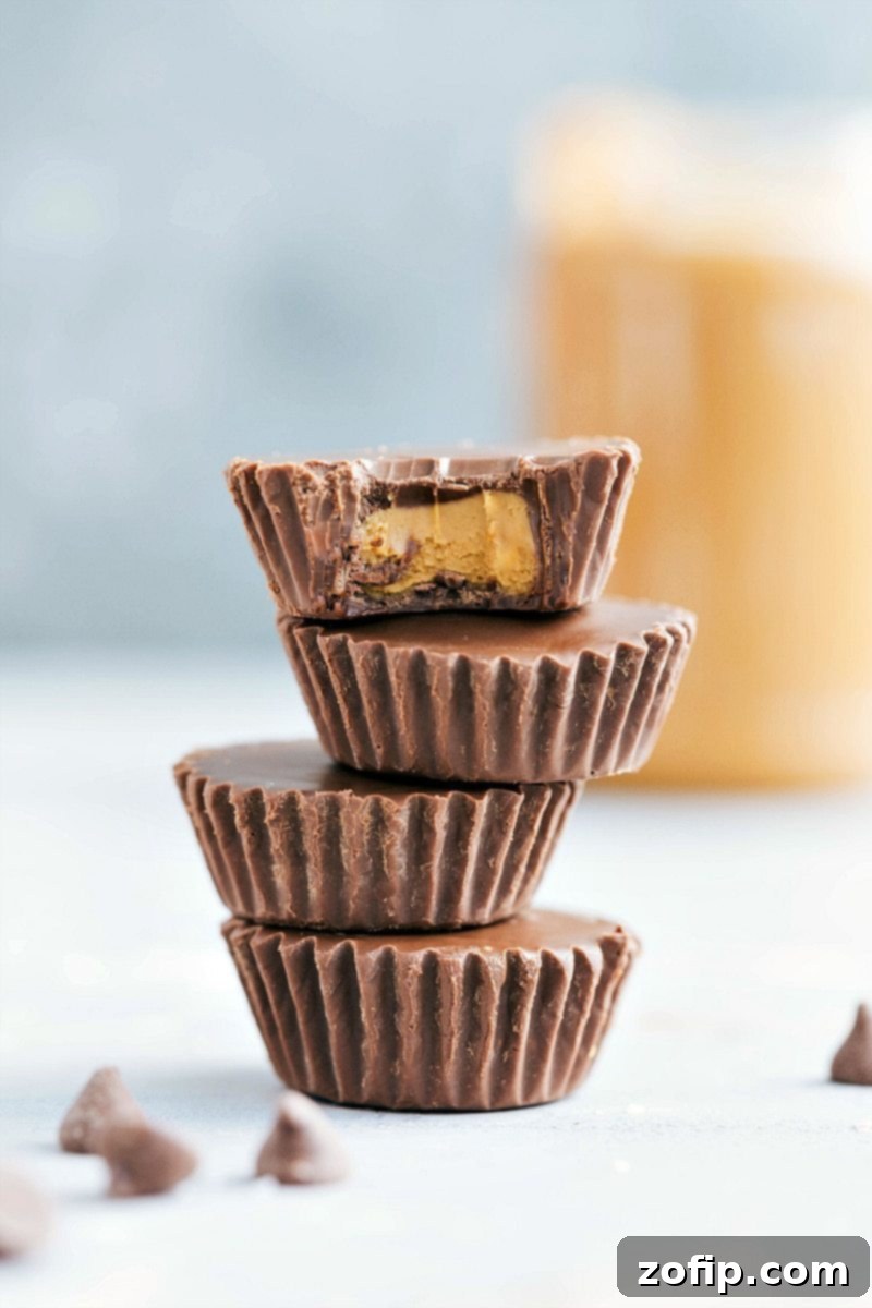 A batch of homemade Cookie Butter Cups chilling in a muffin tin, showcasing the layers before they are fully set and ready to be enjoyed as a delightful no-bake dessert.