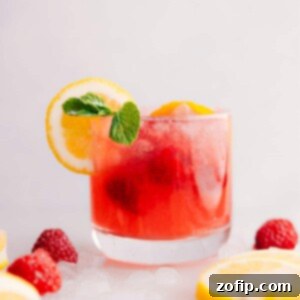 Ruby Raspberry Lemonade 3 Raspberry Lemonade in a cup with garnishes.