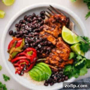 A fully assembled Chicken Fajita Bowl showcasing succulent chicken, vibrant peppers, onions, cilantro-lime rice, and fresh toppings, presented beautifully.