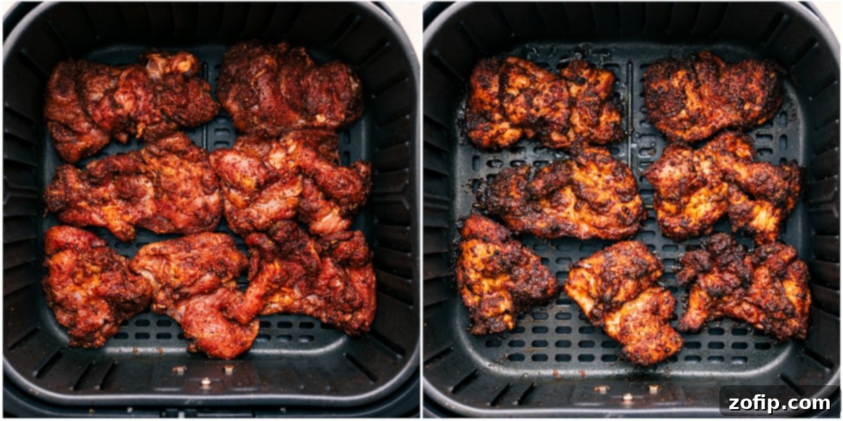Close-up of seasoned chicken pieces cooking in a single layer in an air fryer basket, achieving a perfect golden-brown crispness for delicious fajita bowls.