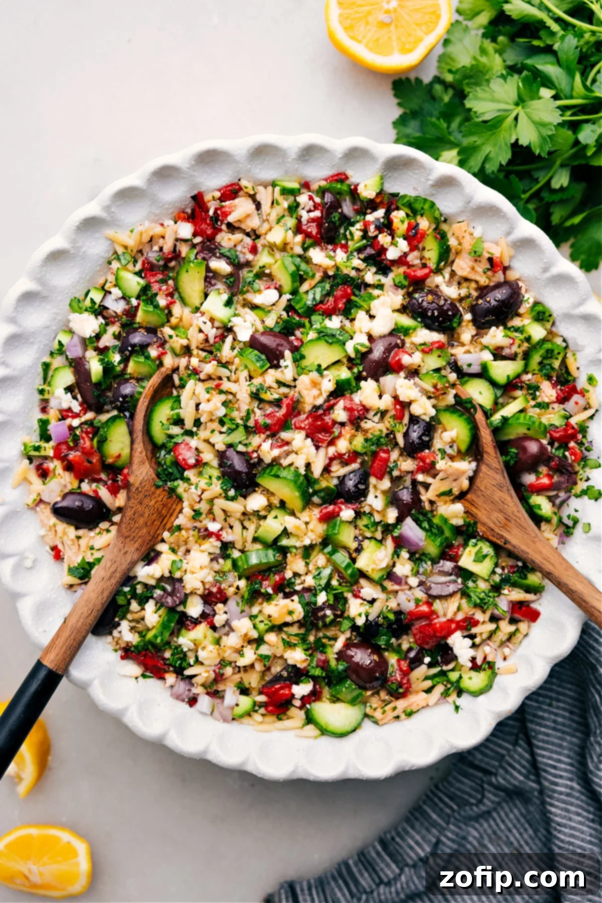 A vibrant Mediterranean Tuna Salad in a bowl, showcasing tender orzo, flaked tuna, colorful vegetables, and fresh herbs, all tossed in a zesty lemon dressing.
