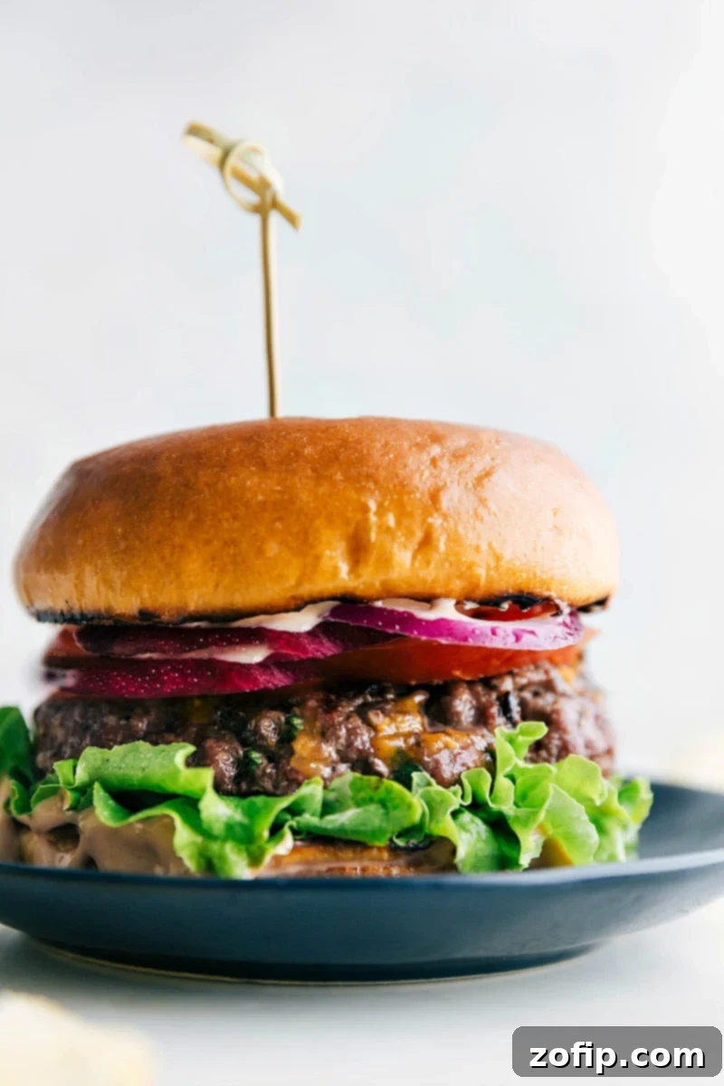 A mouthwatering burger created from this burger recipe, featuring a juicy patty sandwiched between soft buns, topped with a variety of delicious toppings including melted cheese, fresh lettuce, and ripe tomatoes.