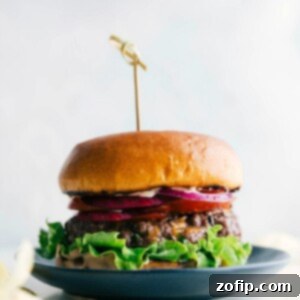 A deliciously cooked hamburger with melted cheese, fresh toppings, and a perfectly toasted bun, ready to be enjoyed.